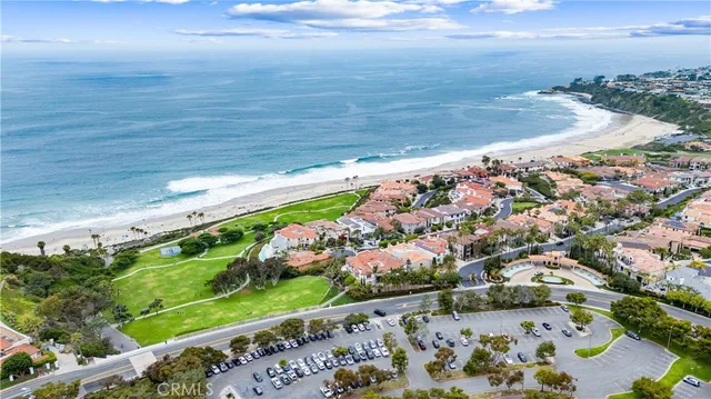 an aerial view of a house with a yard and lake view in back