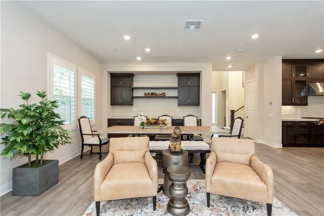 a living room with fireplace furniture and a potted plant