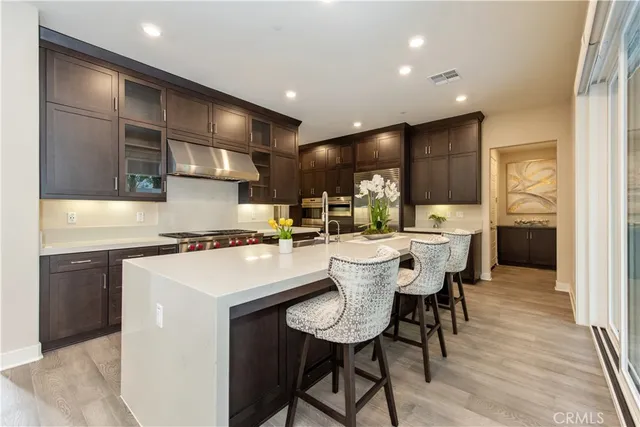 a kitchen with kitchen island a sink table and chairs