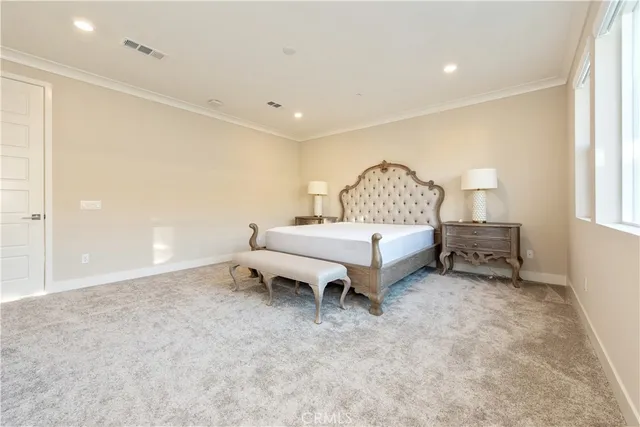 a spacious bedroom with a bed and a window