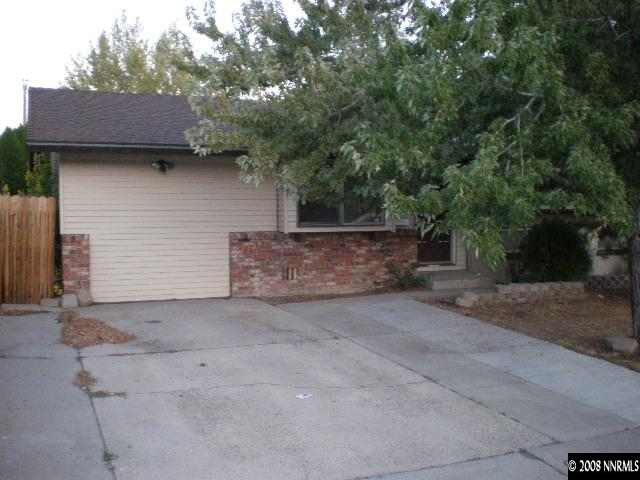 3285 Kings Row Reno, NV 89503 - Photo 2 of 7 a view of a house with a yard and garage