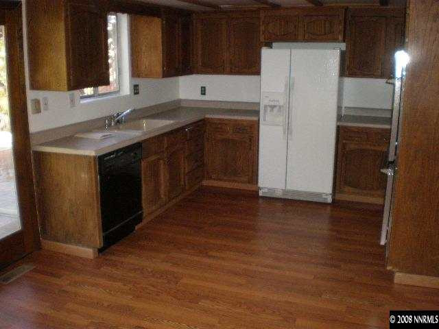3285 Kings Row Reno, NV 89503 - Photo 3 of 7 a kitchen with a sink a refrigerator and cabinets