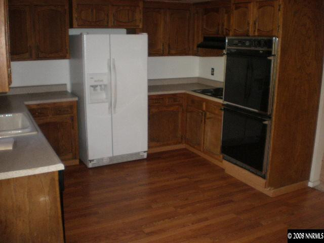 3285 Kings Row Reno, NV 89503 - Photo 4 of 7 a white refrigerator freezer and a stove sitting inside of a kitchen