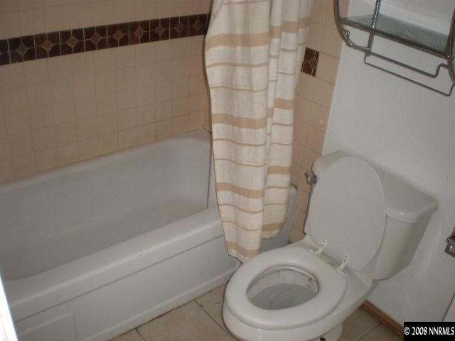 3285 Kings Row Reno, NV 89503 - Photo 6 of 7 a white toilet sitting next to a bath tub