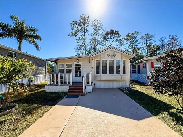 a view of a house with swimming pool and sitting area