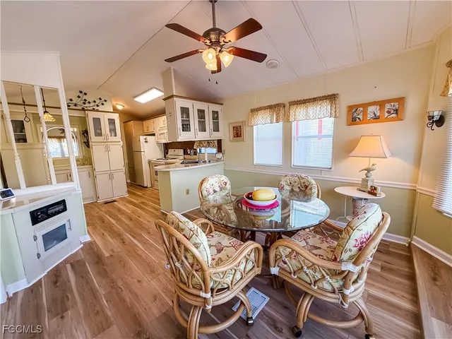 a view of a dining room with furniture and a chandelier