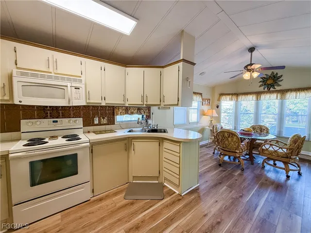 a kitchen with a table chairs stove and cabinets
