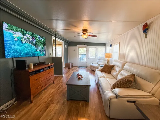 a living room with furniture fireplace and wooden floor
