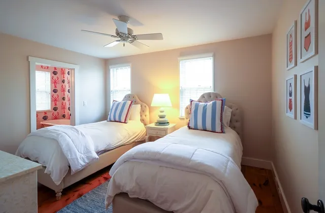 a bedroom with two beds and a chandelier