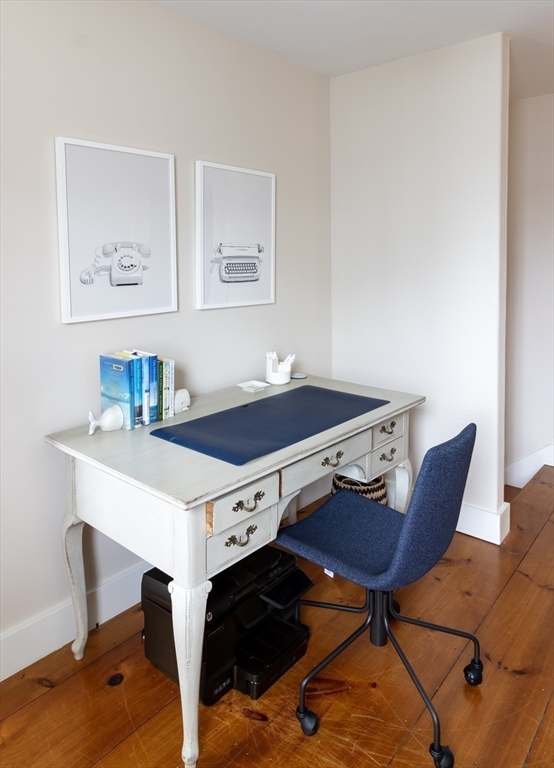10 Lyon Street Nantucket, MA 02554 - Photo 12 of 23 a living room with a table chairs and a wooden floor
