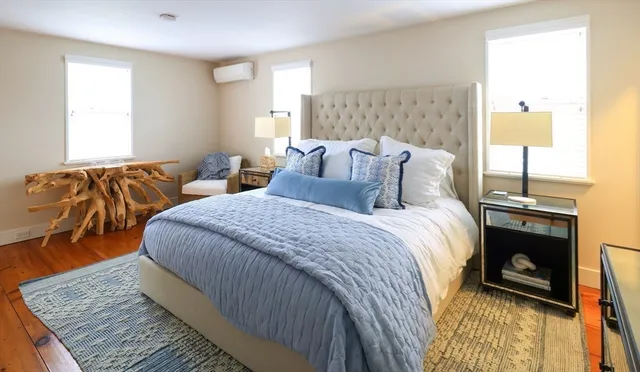 a bed room with two bed and a lamp