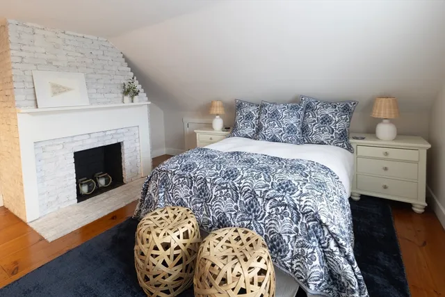 a bedroom with a bed and a fireplace