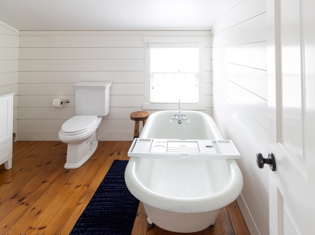 10 Lyon Street Nantucket, MA 02554 - Photo 18 of 23 a bathroom with a toilet sink and mirror