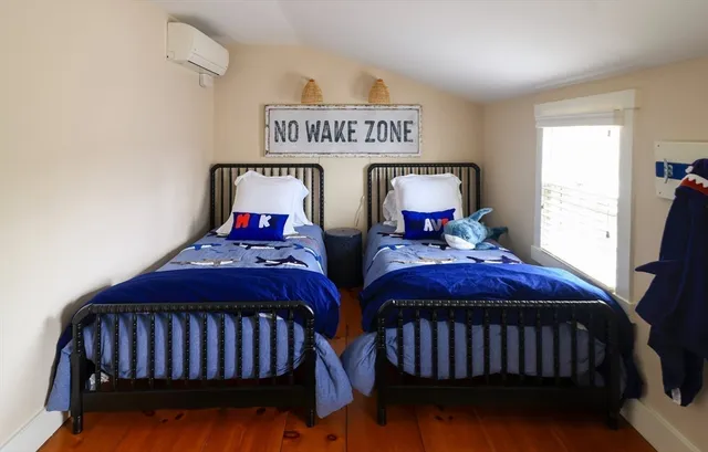 a bedroom with two beds and a dresser