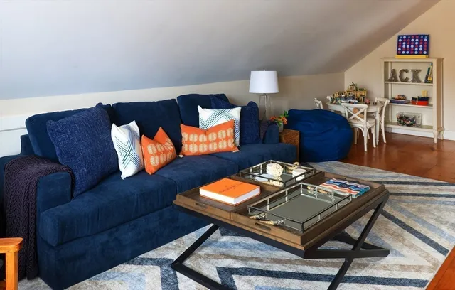 a living room with furniture rug and wooden floor