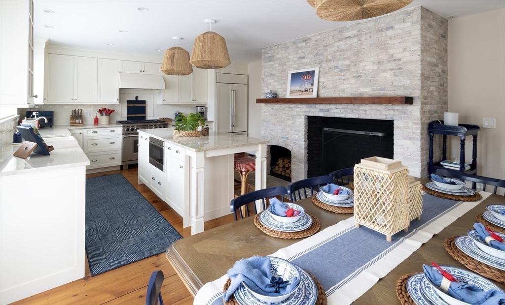 10 Lyon Street Nantucket, MA 02554 - Photo 5 of 23 a kitchen with stainless steel appliances granite countertop a stove and a dining table
