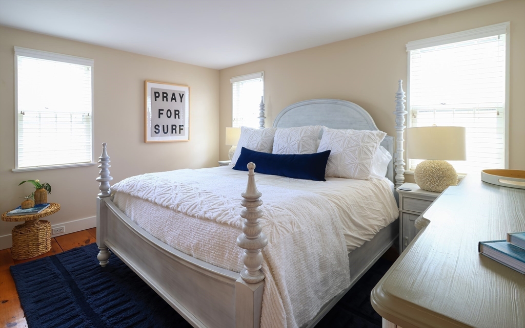 10 Lyon Street Nantucket, MA 02554 - Photo 9 of 23 a bedroom with a bed and wooden floor