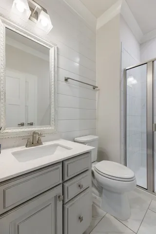 an empty room with wooden floor and ceiling fan