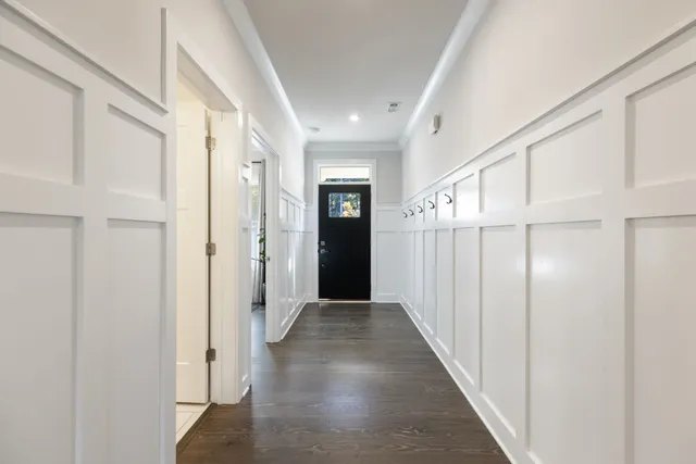 a view of an empty room with wooden floor fireplace and a window