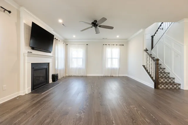 a large kitchen with stainless steel appliances kitchen island granite countertop a large counter top and wooden floors