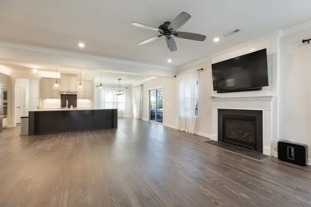 a kitchen with stainless steel appliances a sink a stove and a wooden floors