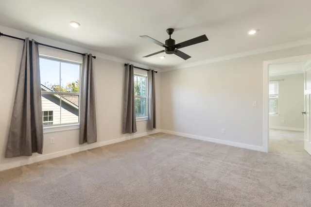 a view of a livingroom with a ceiling fan and window