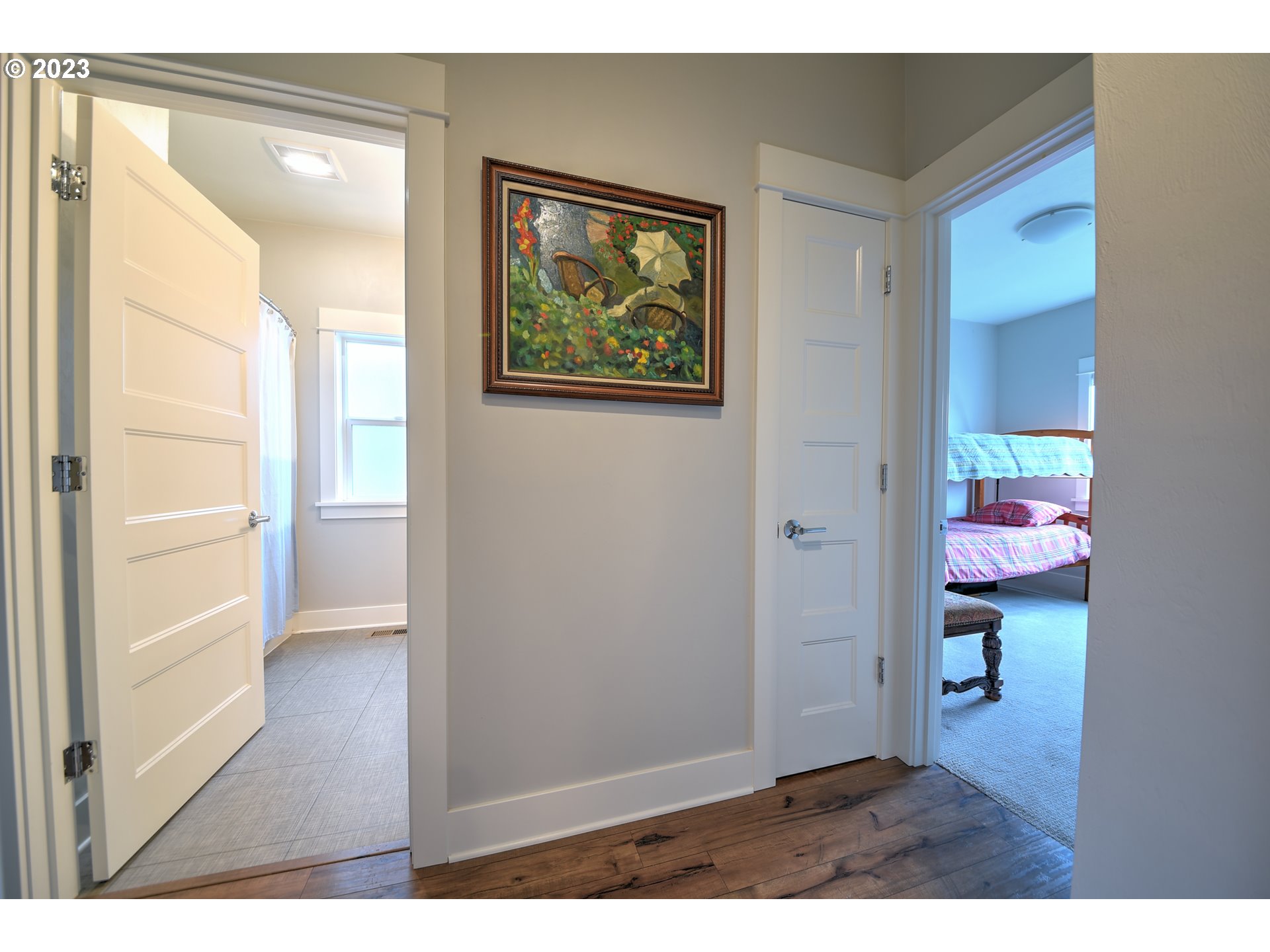 851 Hamilton Street Springfield, OR 97477 - Photo 19 of 31 a view of a hallway with wooden floor and a bathroom