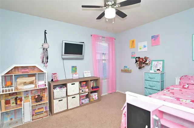 a bedroom with furniture and a flat screen tv