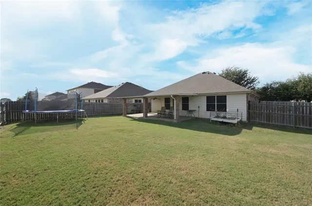 a front view of a house with swimming pool and a yard