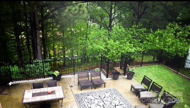 a view of backyard with seating area and green space