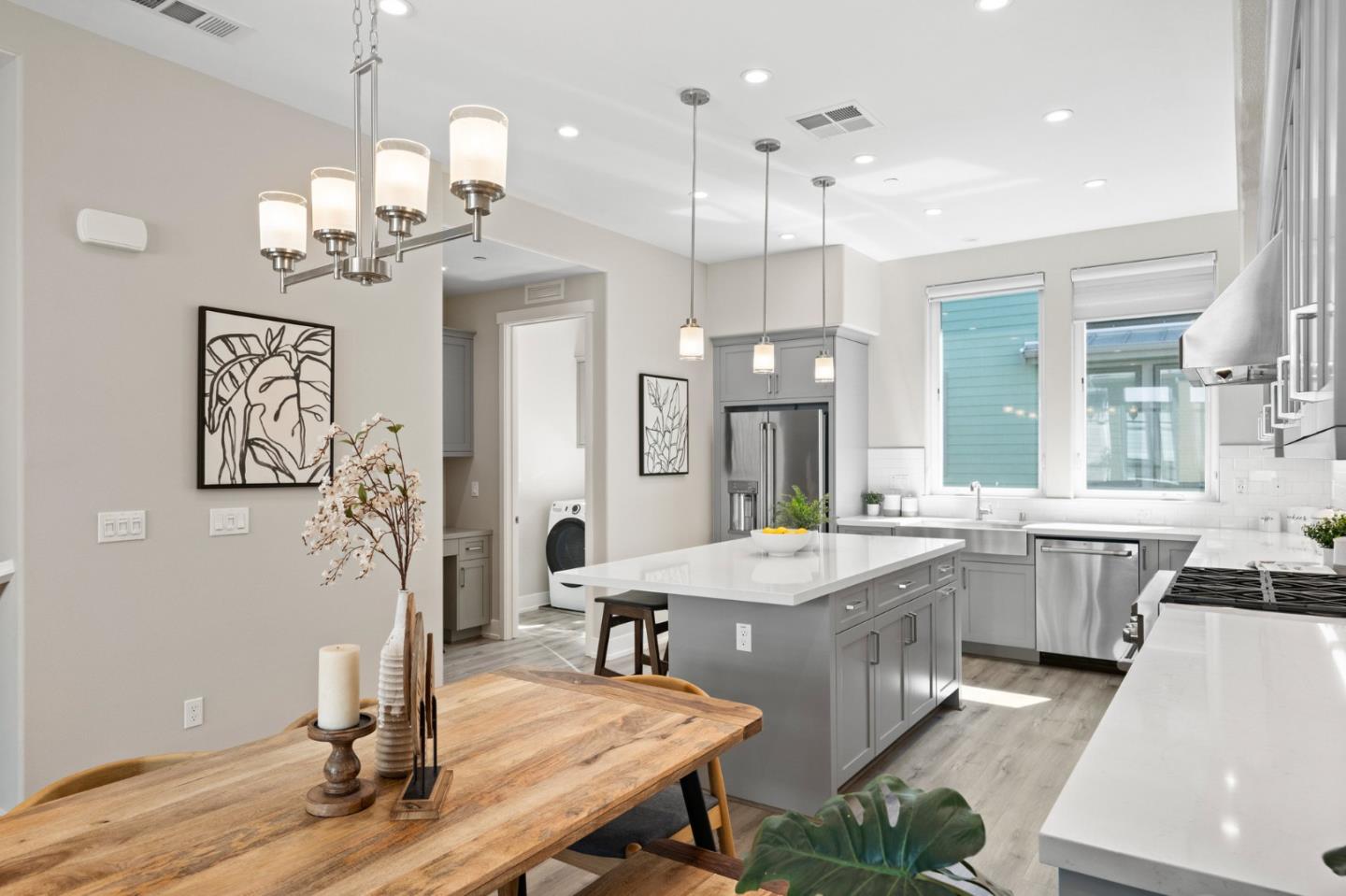 653 Agave Terrace Sunnyvale, CA 94086 - Photo 15 of 44 a dining hall with stainless steel appliances kitchen island granite countertop furniture wooden floor and a chandelier