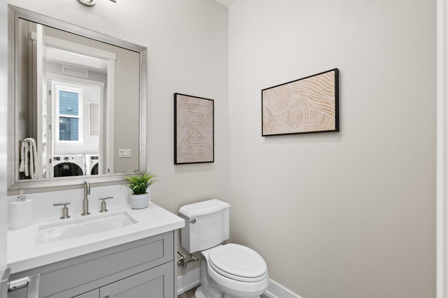653 Agave Terrace Sunnyvale, CA 94086 - Photo 23 of 44 a bathroom with a toilet a sink and mirror