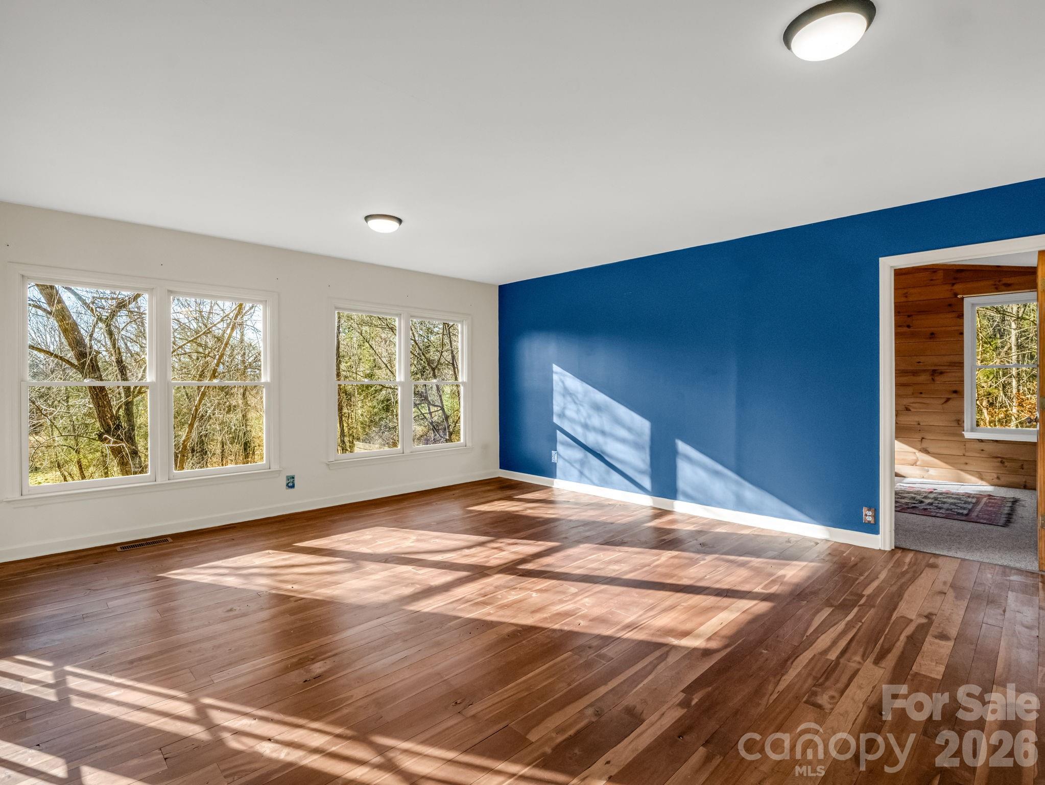 3205 Collinsville Road Columbus, NC 28722 - Photo 15 of 48 a view of an empty room with a window and wooden floor