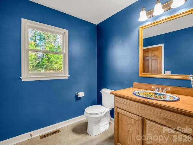 a view of a yard with wooden fence