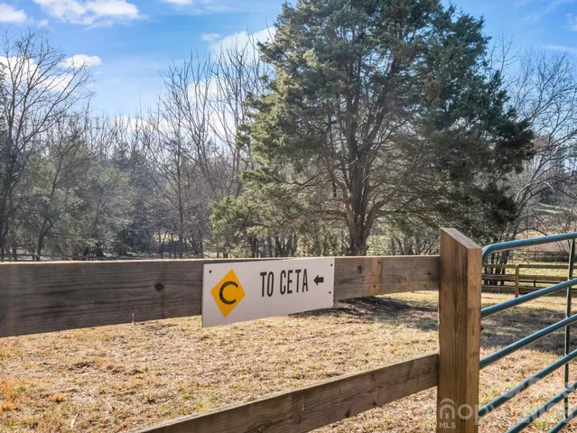 a view of a wooden fence and trees