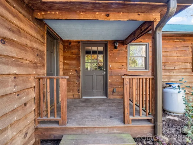 a kitchen with stainless steel appliances granite countertop wooden cabinets a stove a sink and a large window