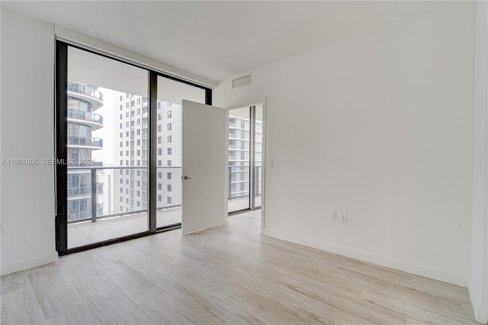 45 Southwest 9th Street, Unit 2408 Miami, FL 33130 - Photo 16 of 37 wooden floor in an empty room with a window