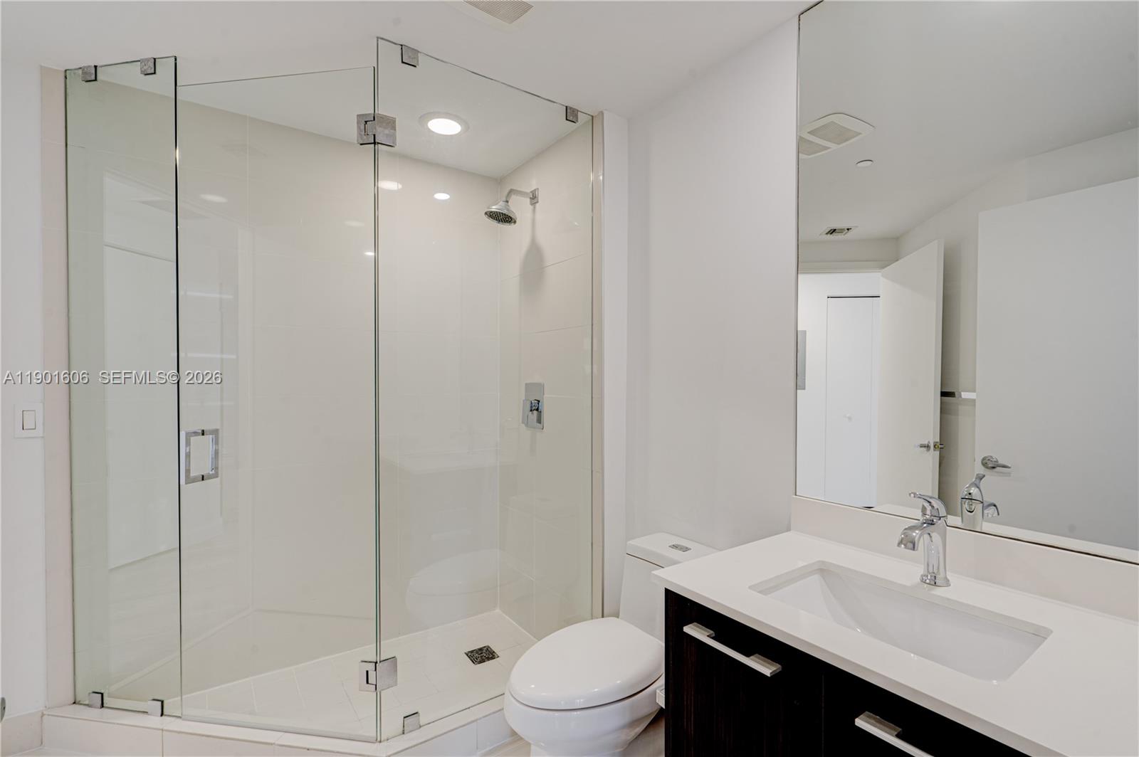 45 Southwest 9th Street, Unit 2408 Miami, FL 33130 - Photo 18 of 37 a bathroom with a sink a toilet and shower