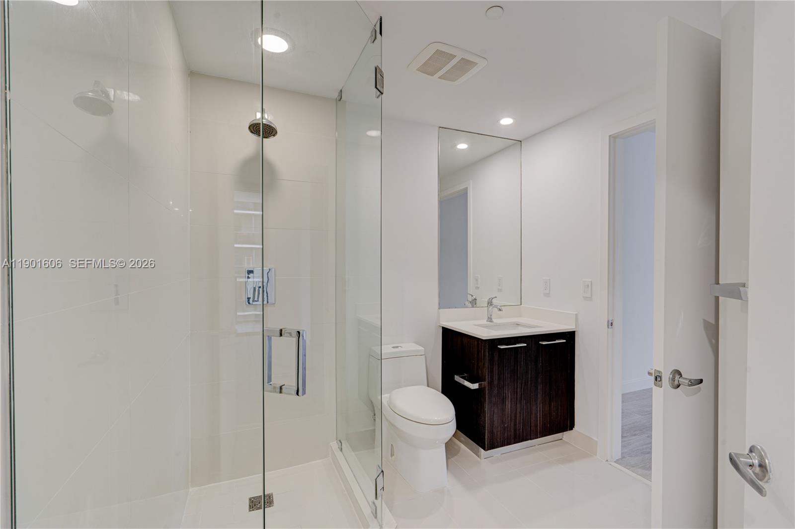 45 Southwest 9th Street, Unit 2408 Miami, FL 33130 - Photo 19 of 37 a bathroom with a sink toilet and shower