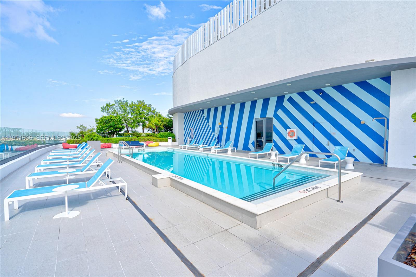 45 Southwest 9th Street, Unit 2408 Miami, FL 33130 - Photo 23 of 37 a view of swimming pool with a couches and chairs
