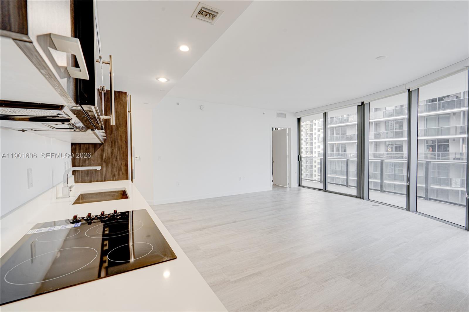 45 Southwest 9th Street, Unit 2408 Miami, FL 33130 - Photo 5 of 37 a view of an empty room with wooden floor