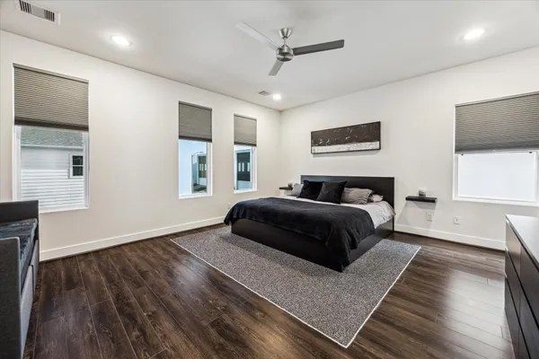 a bedroom with a bed and wooden floor