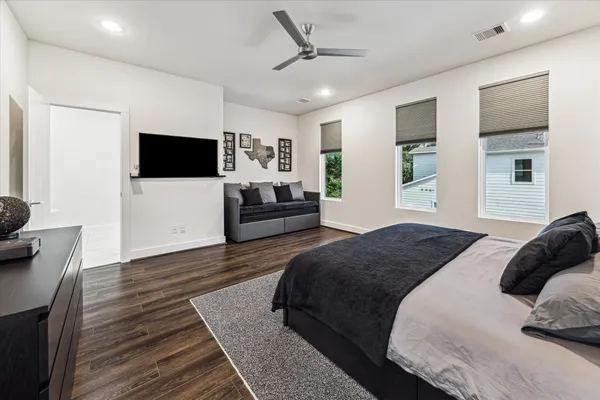a bedroom with a bed and a flat screen tv