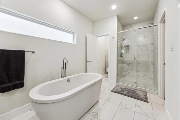 a white bath tub sitting next to a bathroom
