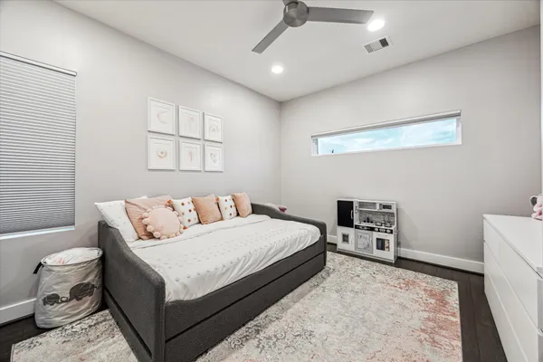a bed room with a bed and a chair