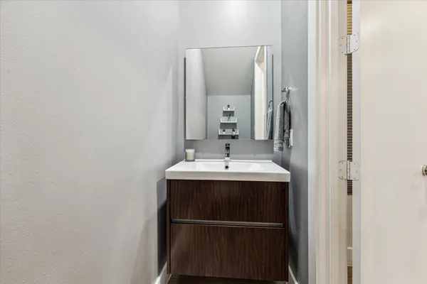 a bathroom with a sink and mirror