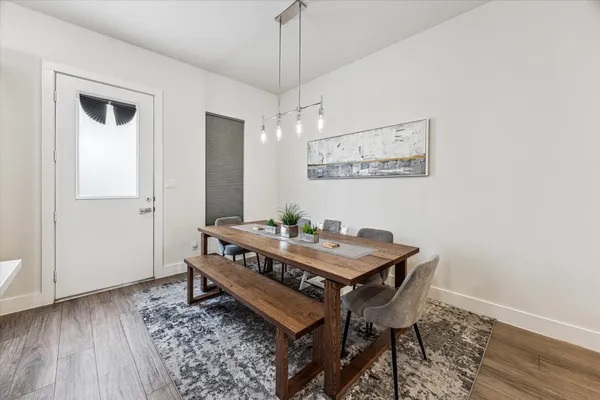 a view of a room that has a table and chairs in it