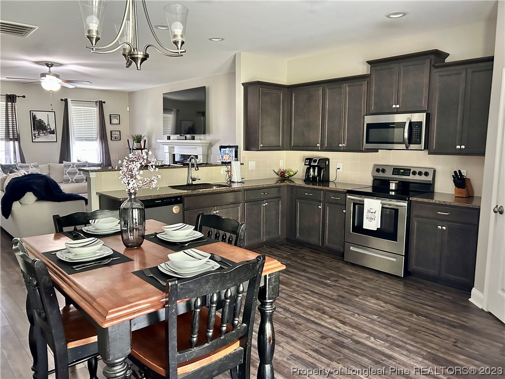 96 Eaker Drive Cameron, NC 28326 - Photo 12 of 41 a kitchen with granite countertop a sink counter top space stainless steel appliances and cabinets