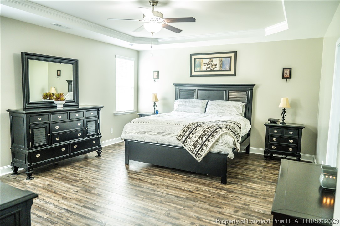 96 Eaker Drive Cameron, NC 28326 - Photo 17 of 41 a bedroom with a bed and wooden floor