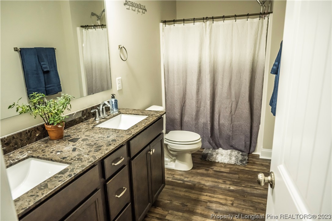 96 Eaker Drive Cameron, NC 28326 - Photo 30 of 41 a bathroom with a granite countertop sink and a mirror